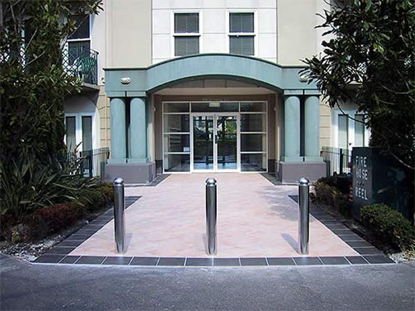 Stainless steel bollards in building forecourt